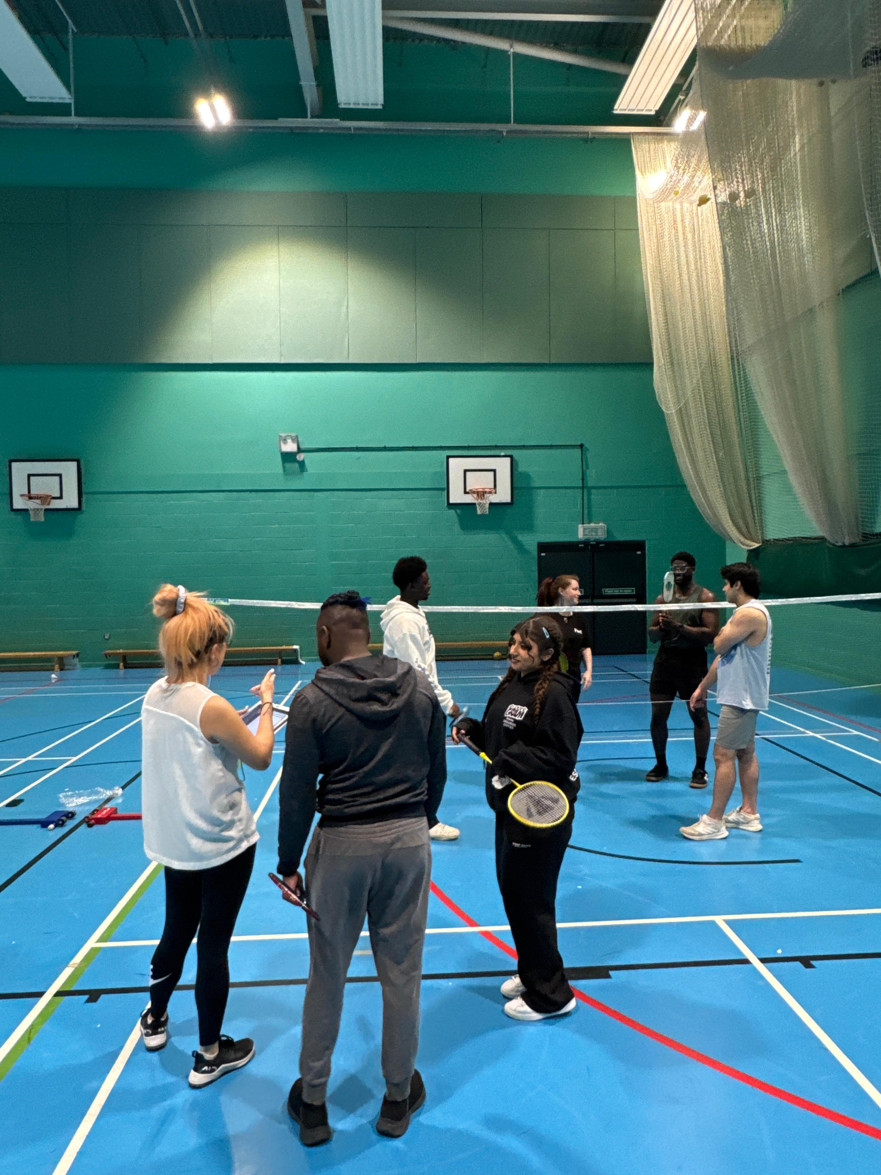 Doubles match during an Angel Wings social badminton session
